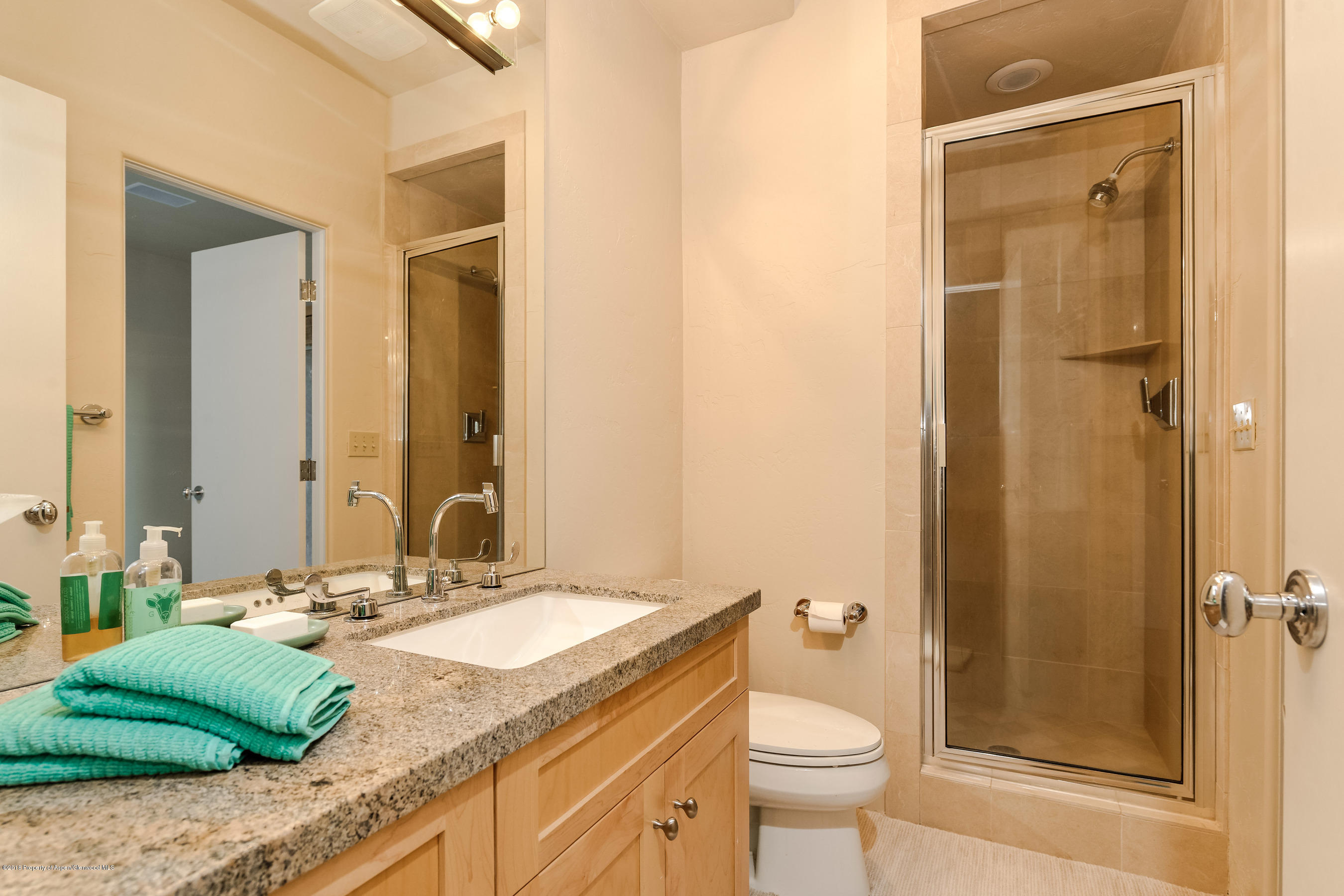 404 Wild Spring Lane Basalt, CO 81621 - Photo 14 of 25 a bathroom with a granite countertop sink toilet and shower
