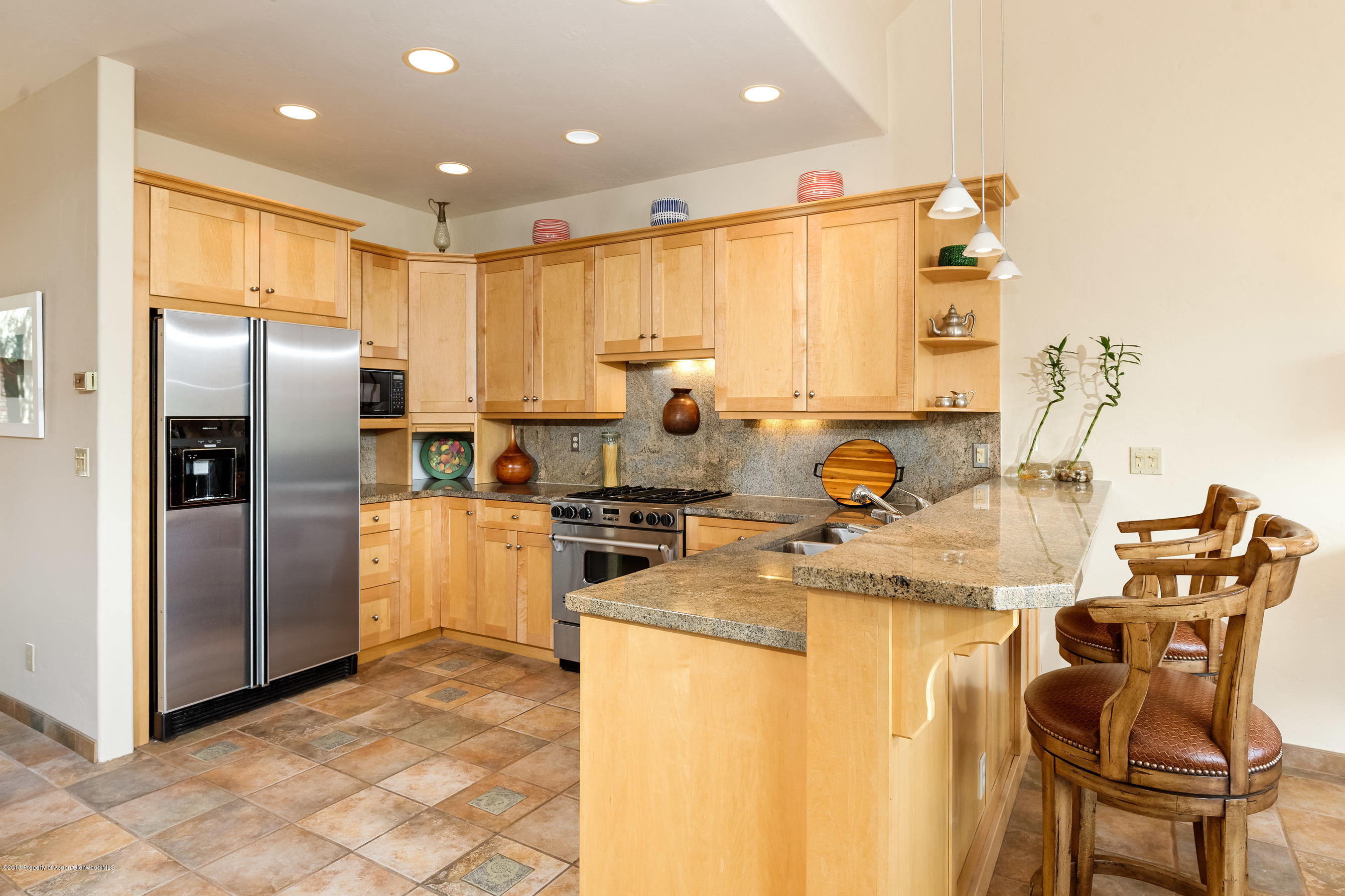 404 Wild Spring Lane Basalt, CO 81621 - Photo 5 of 25 a kitchen with refrigerator and chairs