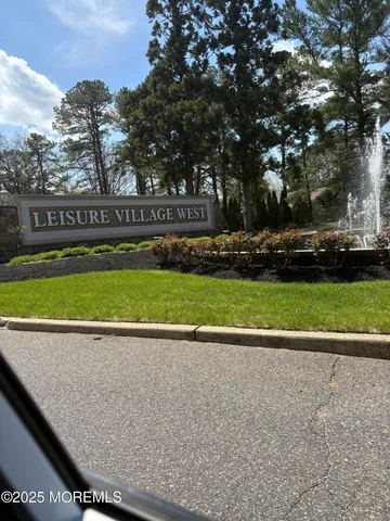 a view of swimming pool with a yard and large trees