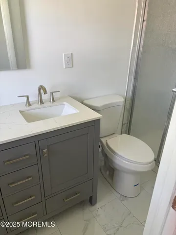 a white toilet sitting next to a bathroom sink