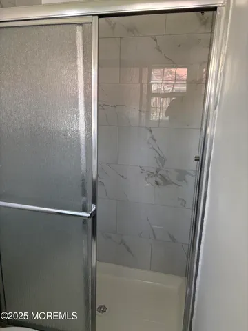 a bathroom with a glass shower door