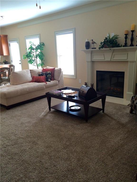 718 Channel Lane Lawrenceville, GA 30046 - Photo 4 of 16 a living room with furniture and a fireplace