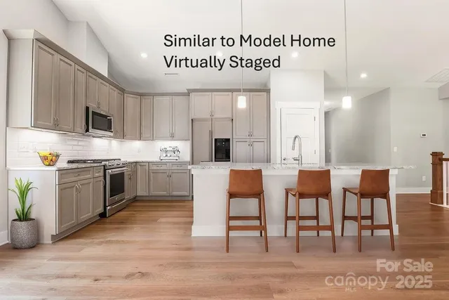 a large kitchen with lots of white cabinets a sink and appliances