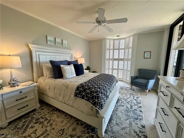 a bedroom with a bed a couch and dresser