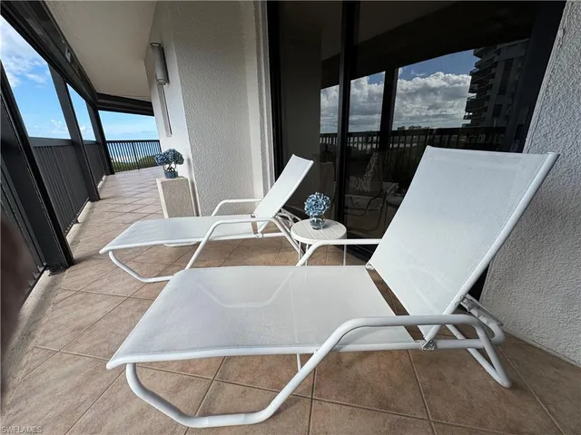 a view of swimming pool with furniture and window