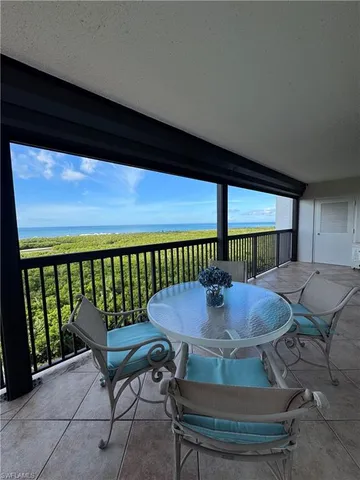 a view of a balcony with table and chairs