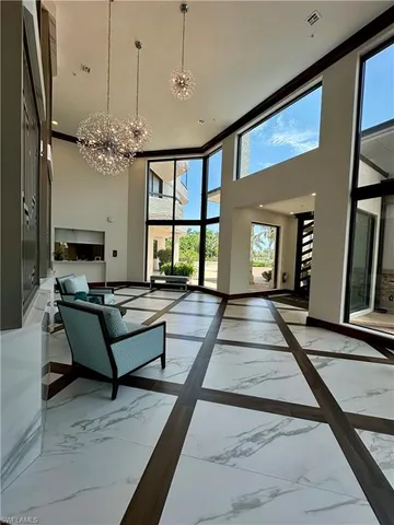 a living room with furniture and a chandelier