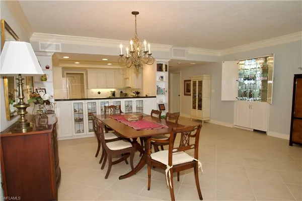 a view of a dining room with furniture and chandelier