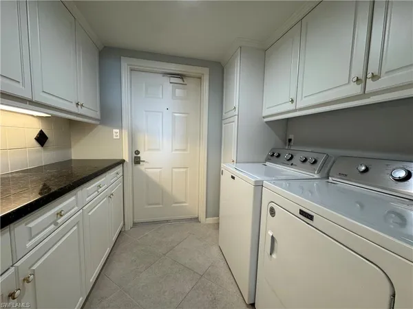 a utility room with closet dryer and washer