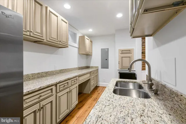 a kitchen with stainless steel appliances granite countertop a stove a sink and a microwave