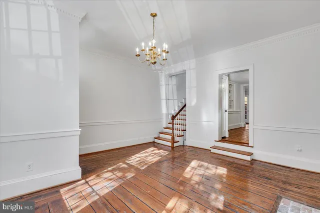 a view of a room with wooden floor and staircase
