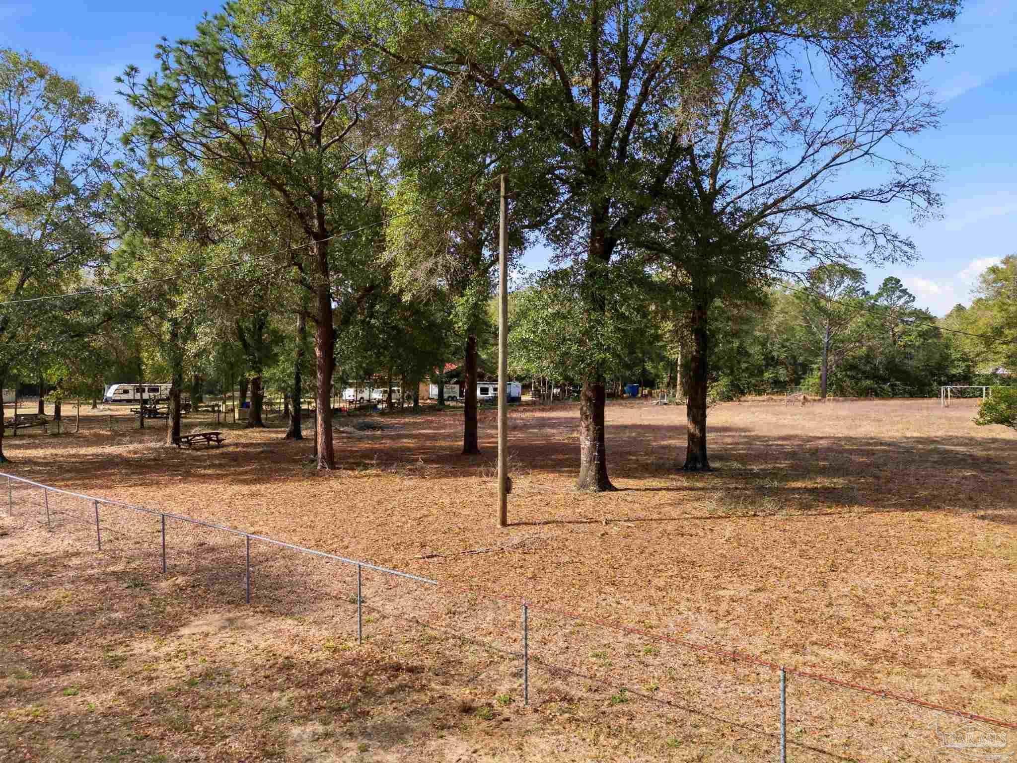 0 Howard Lane Milton, FL 32570 - Photo 3 of 9 a street view with large trees