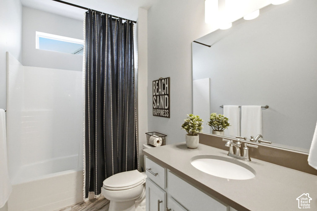 986 South Old Farm Road Heber City, UT 84032 - Photo 28 of 51 Modern vanity with an integrated sink and brushed nickel faucet, full-width mirror, and a white bathtub with an overhead window