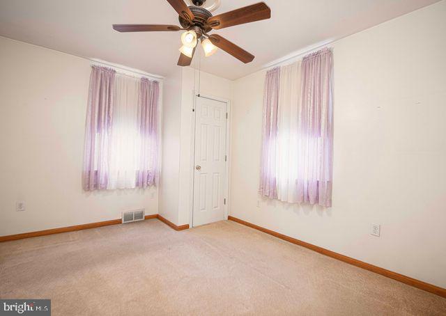 1818 Elk Road Baltimore, MD 21221 - Photo 27 of 45 an empty room with windows and fan