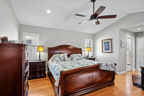 a bedroom with a bed and a chandelier