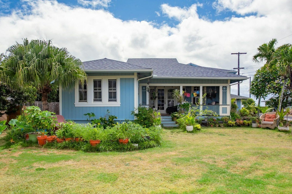 a front view of a house with a yard and porch