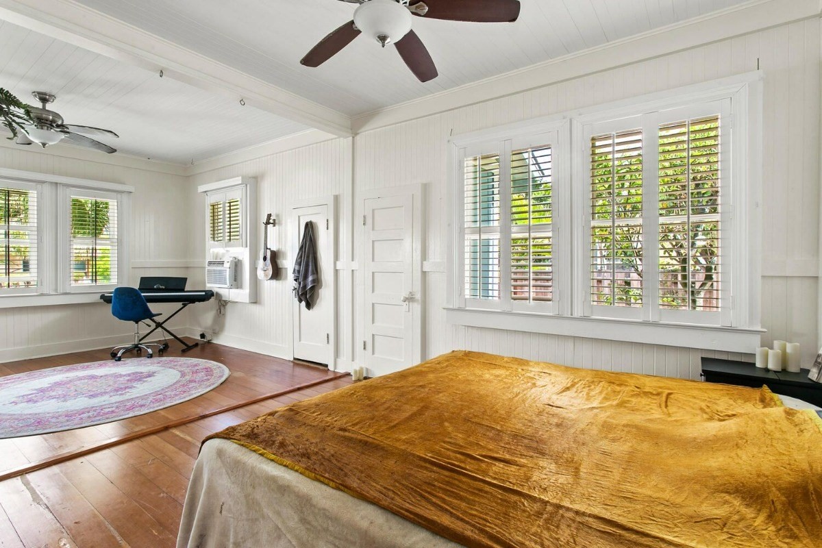 1054 Kealoha Road, Unit 2 Kapaa, HI 96746 - Photo 5 of 13 a spacious bedroom with a bed and glass windows