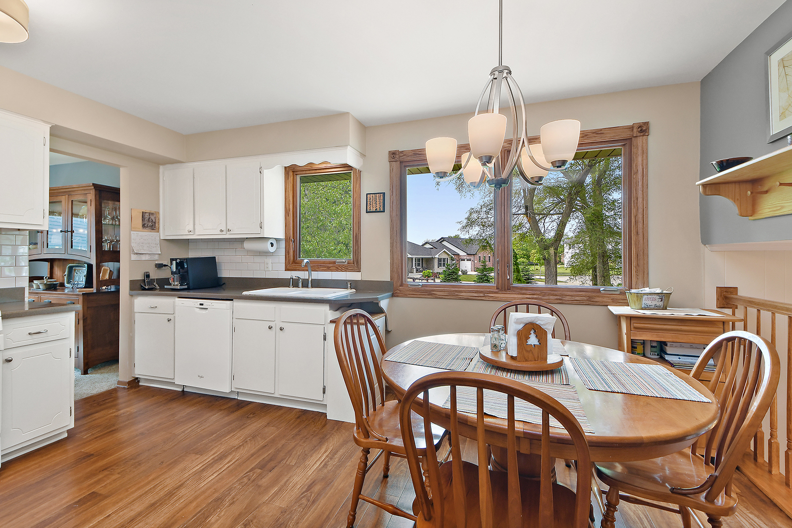 10918 3rd Street Mokena, IL 60448 - Photo 18 of 40 a kitchen with granite countertop a dining table chairs and white cabinets