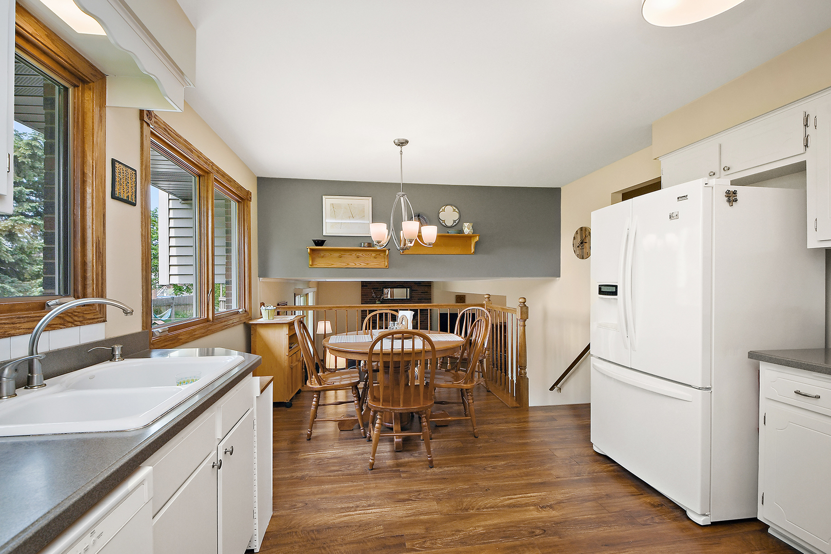 10918 3rd Street Mokena, IL 60448 - Photo 20 of 40 a kitchen with stainless steel appliances granite countertop a refrigerator a stove a dining table and chairs with wooden floor
