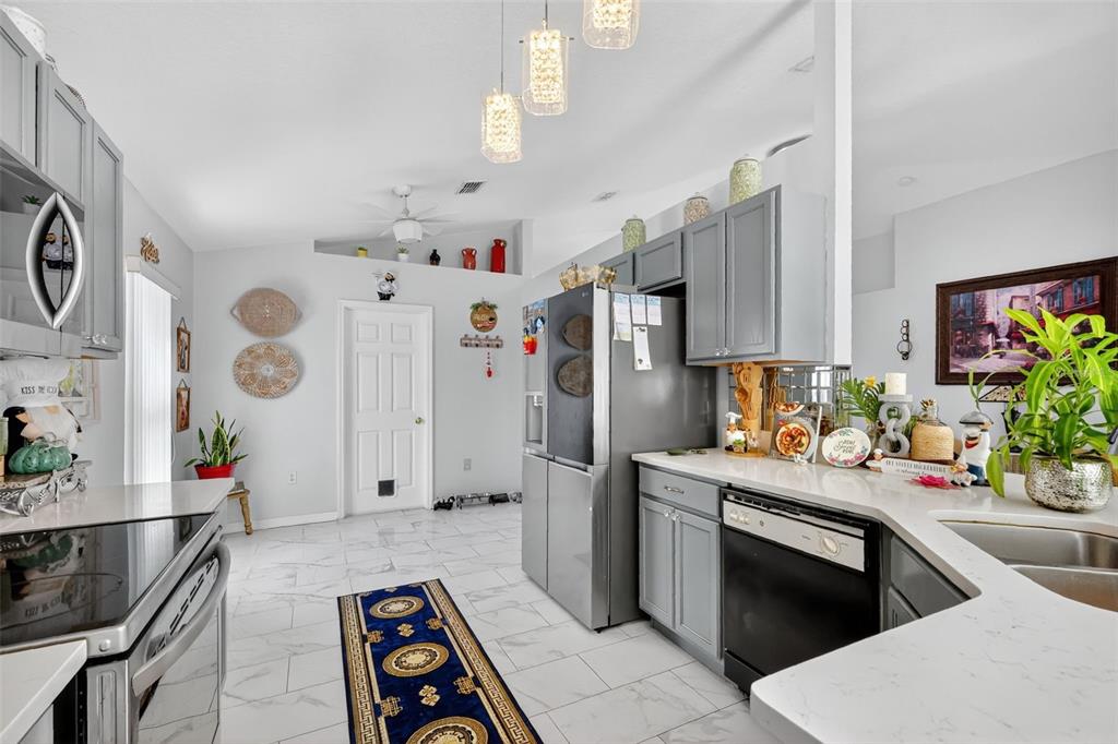 2442 Foxhollow Road Tavares, FL 32778 - Photo 15 of 28 a kitchen with white cabinets and stainless steel appliances