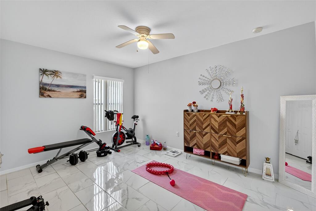 2442 Foxhollow Road Tavares, FL 32778 - Photo 17 of 28 a view of a room with gym equipment