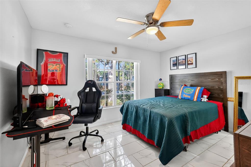 2442 Foxhollow Road Tavares, FL 32778 - Photo 18 of 28 a bedroom with a bed and dresser