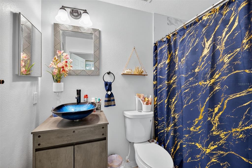 2442 Foxhollow Road Tavares, FL 32778 - Photo 19 of 28 a bathroom with a toilet sink and mirror