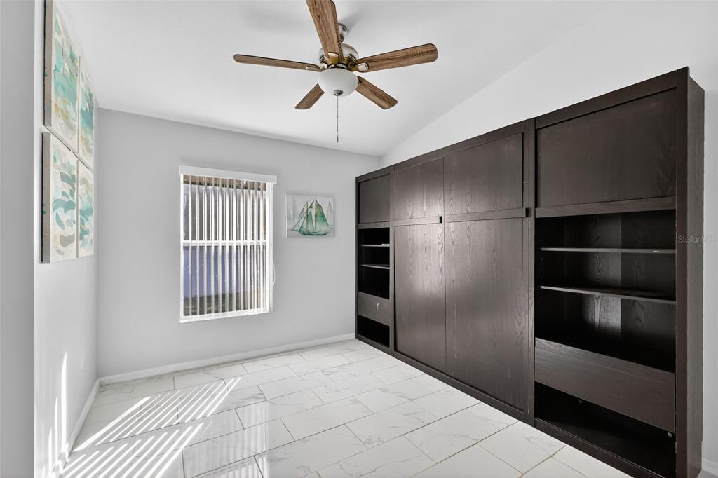 2442 Foxhollow Road Tavares, FL 32778 - Photo 22 of 28 a view of an empty room with a window