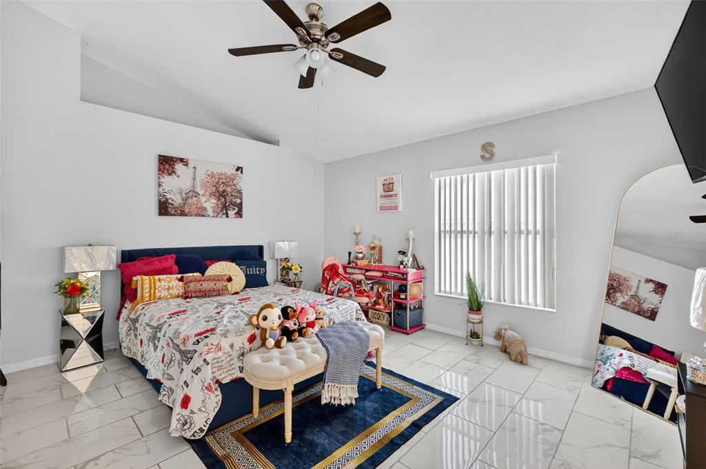 2442 Foxhollow Road Tavares, FL 32778 - Photo 23 of 28 a living room with furniture and a baby crib