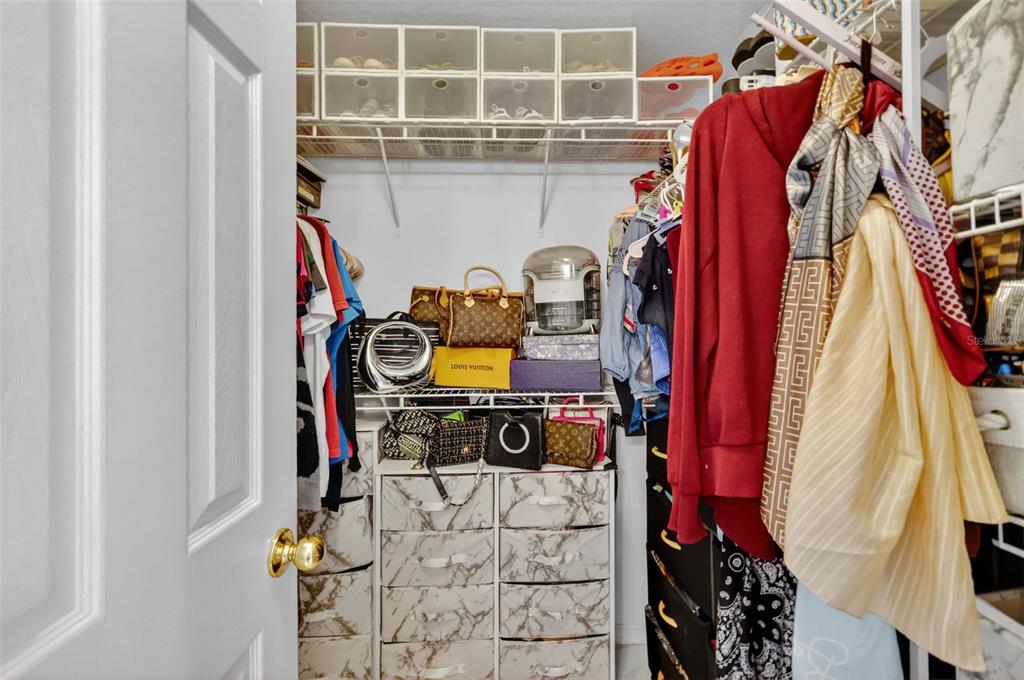 2442 Foxhollow Road Tavares, FL 32778 - Photo 25 of 28 a view of walk in closet with clothes and shoes