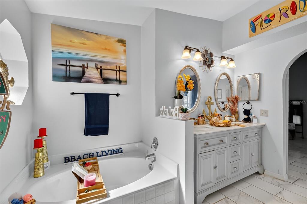 2442 Foxhollow Road Tavares, FL 32778 - Photo 27 of 28 a bathroom with a sink mirror and window