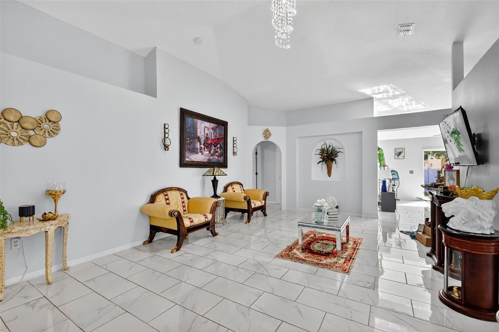 2442 Foxhollow Road Tavares, FL 32778 - Photo 8 of 28 a living room with furniture and a flat screen tv