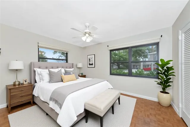 a bed room with a bed and a potted plant