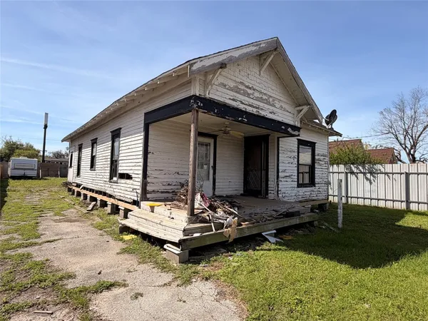 a front view of a house with a yard table and chairs