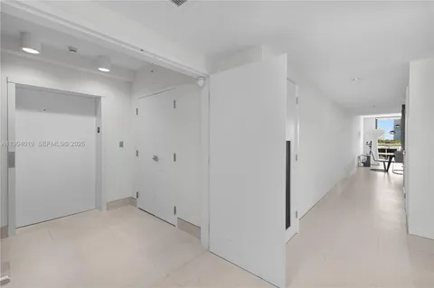a large white bed in a white room