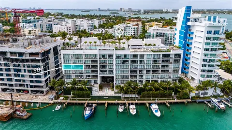 an aerial view of residential houses with outdoor space and river