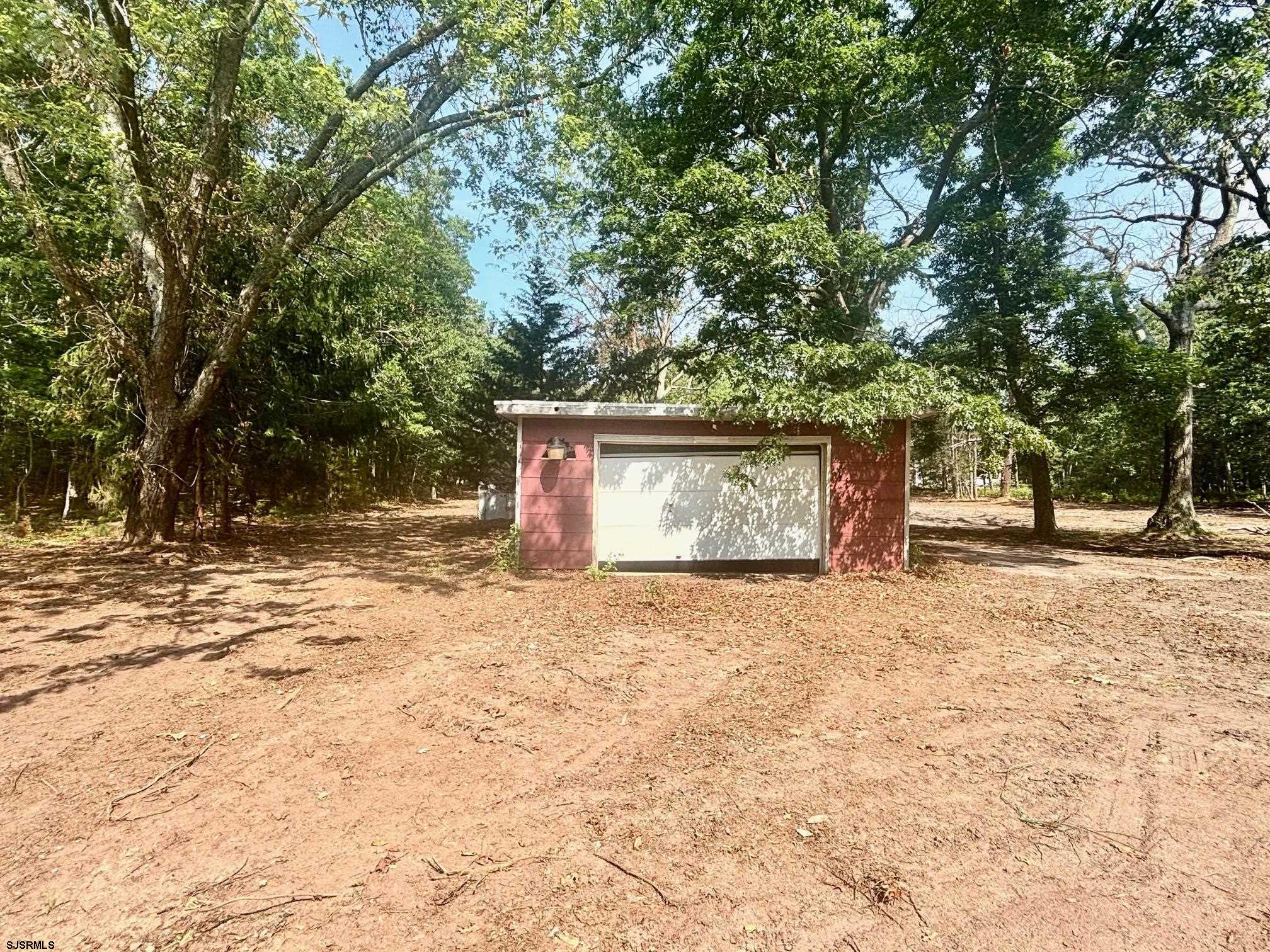 117 Leeds Point Road Galloway Township, NJ 08205 - Photo 4 of 28 a outdoor view covered with trees