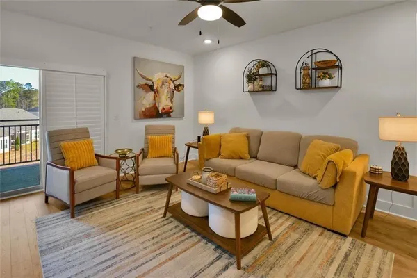 a living room with furniture kitchen view and a fireplace