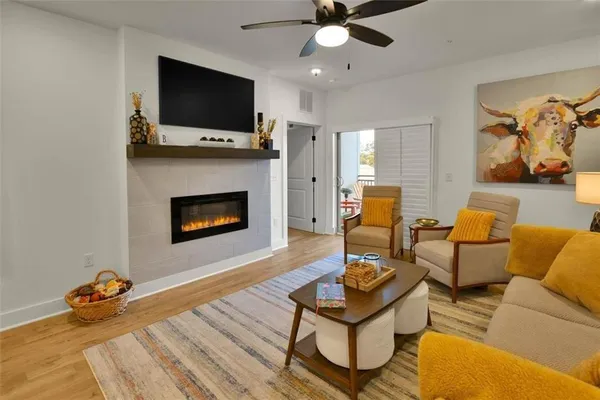 a living room with furniture and a wooden floor