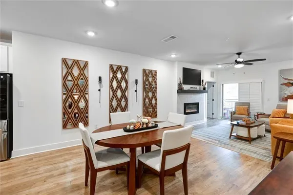 a kitchen with a dining table chairs and view of living room