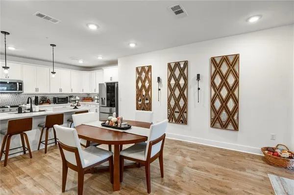 a view of a dining room with furniture and wooden floor