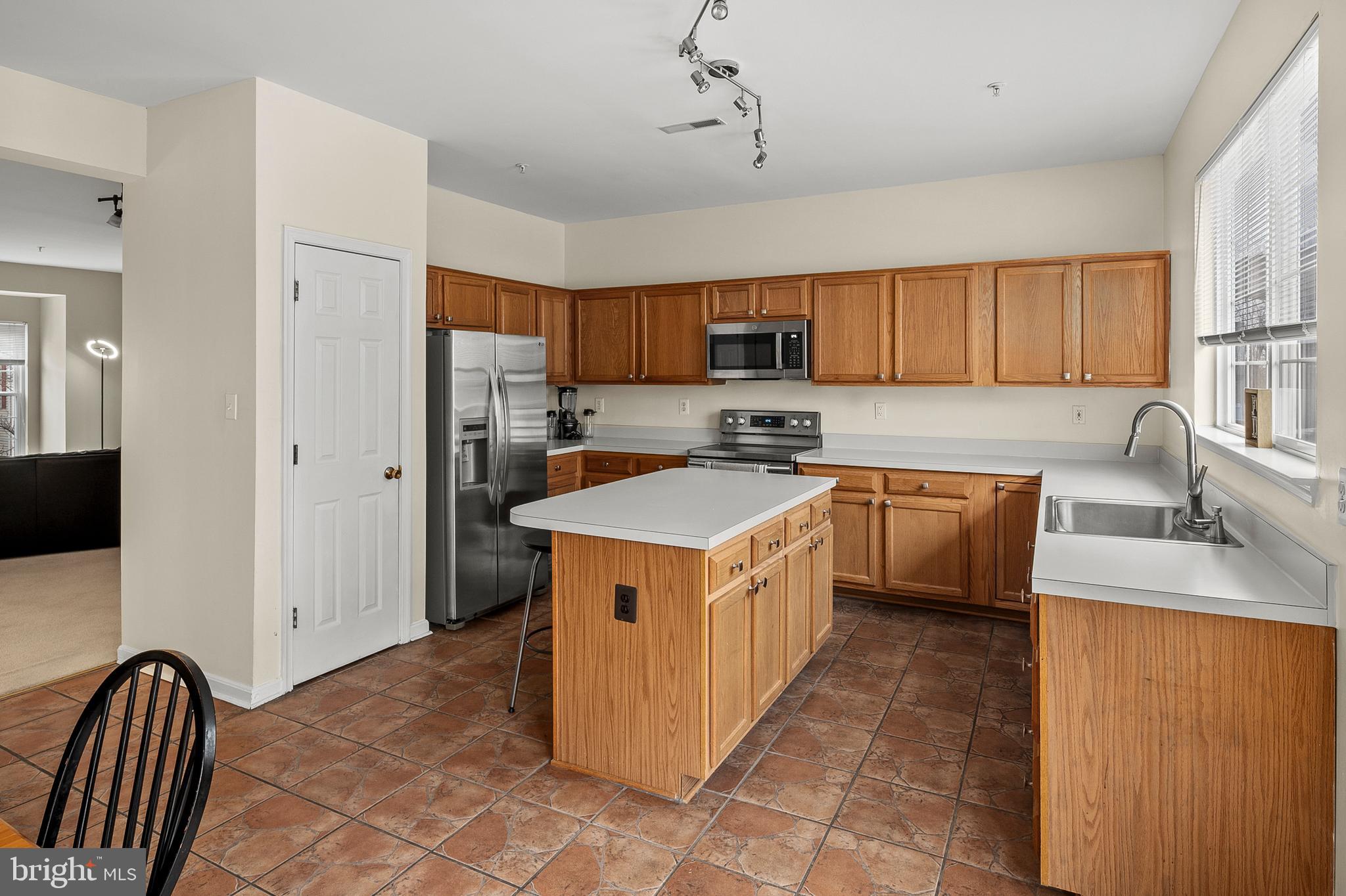 2720 Summers Ridge Drive Odenton, MD 21113 - Photo 9 of 29 a kitchen with a stove sink and a refrigerator