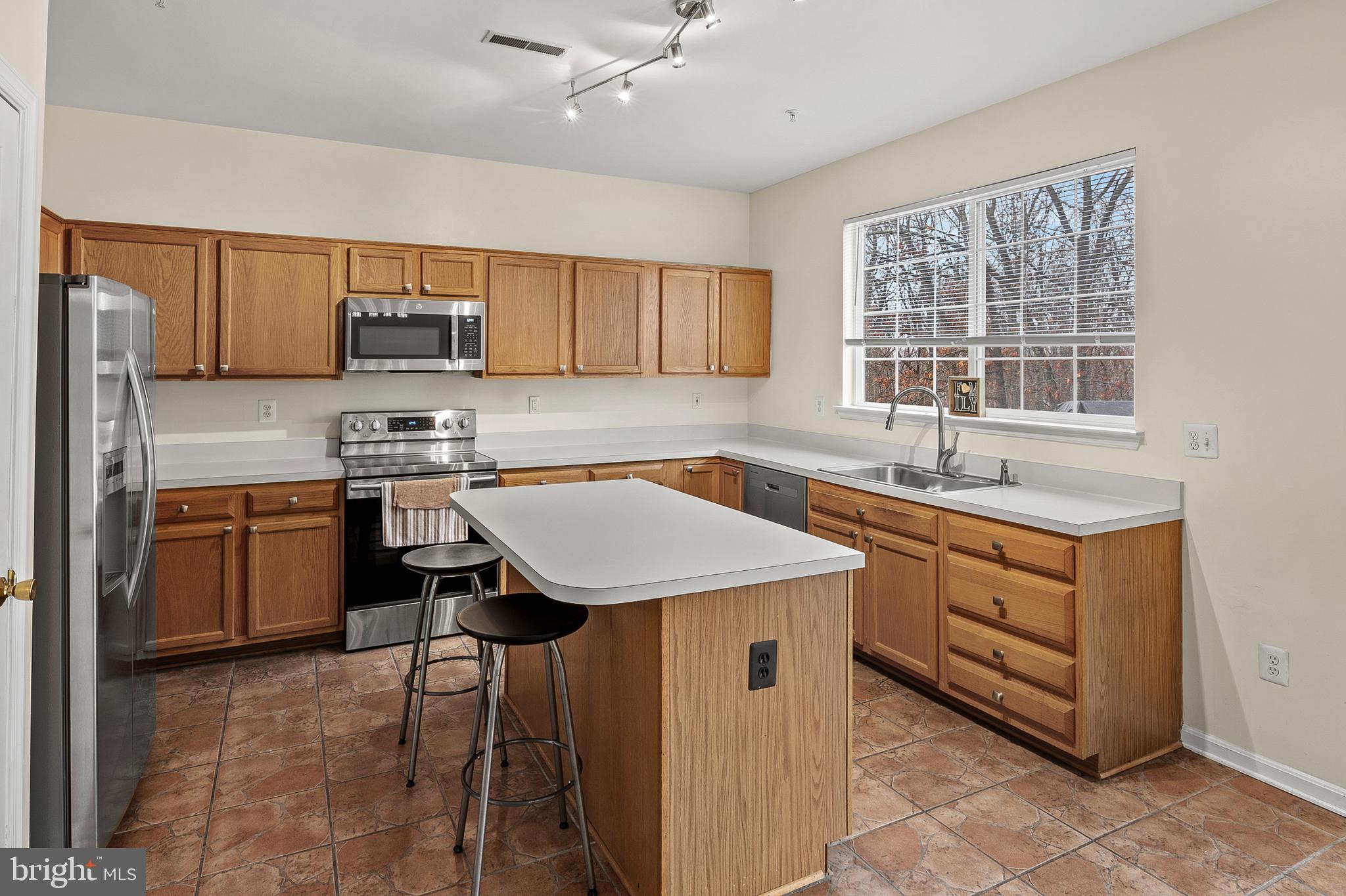 2720 Summers Ridge Drive Odenton, MD 21113 - Photo 10 of 29 a kitchen with a sink stove and microwave