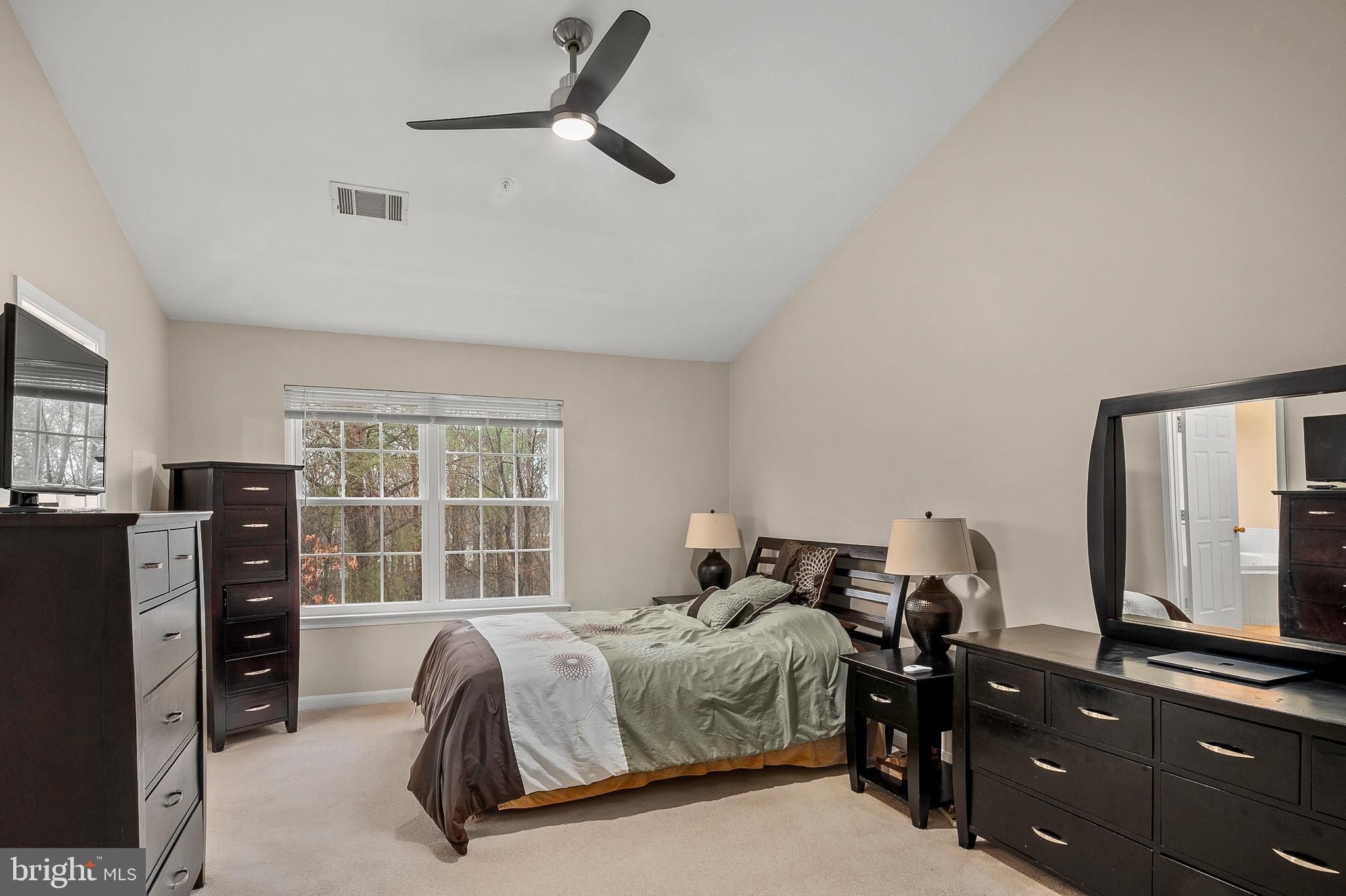 2720 Summers Ridge Drive Odenton, MD 21113 - Photo 15 of 29 a bedroom with a bed and dresser with mirror