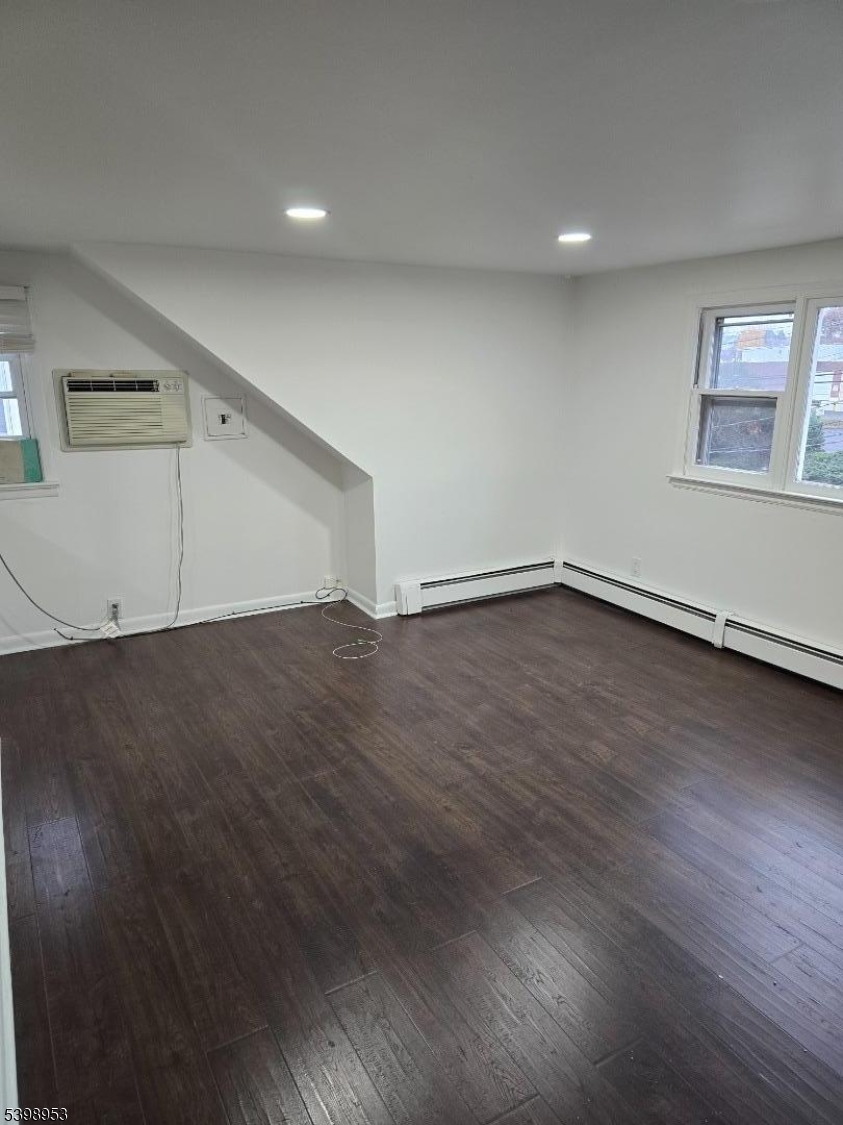 18 Donna Drive, Unit 2 Wood-Ridge, NJ 07075 - Photo 14 of 15 an empty room with wooden floor and windows