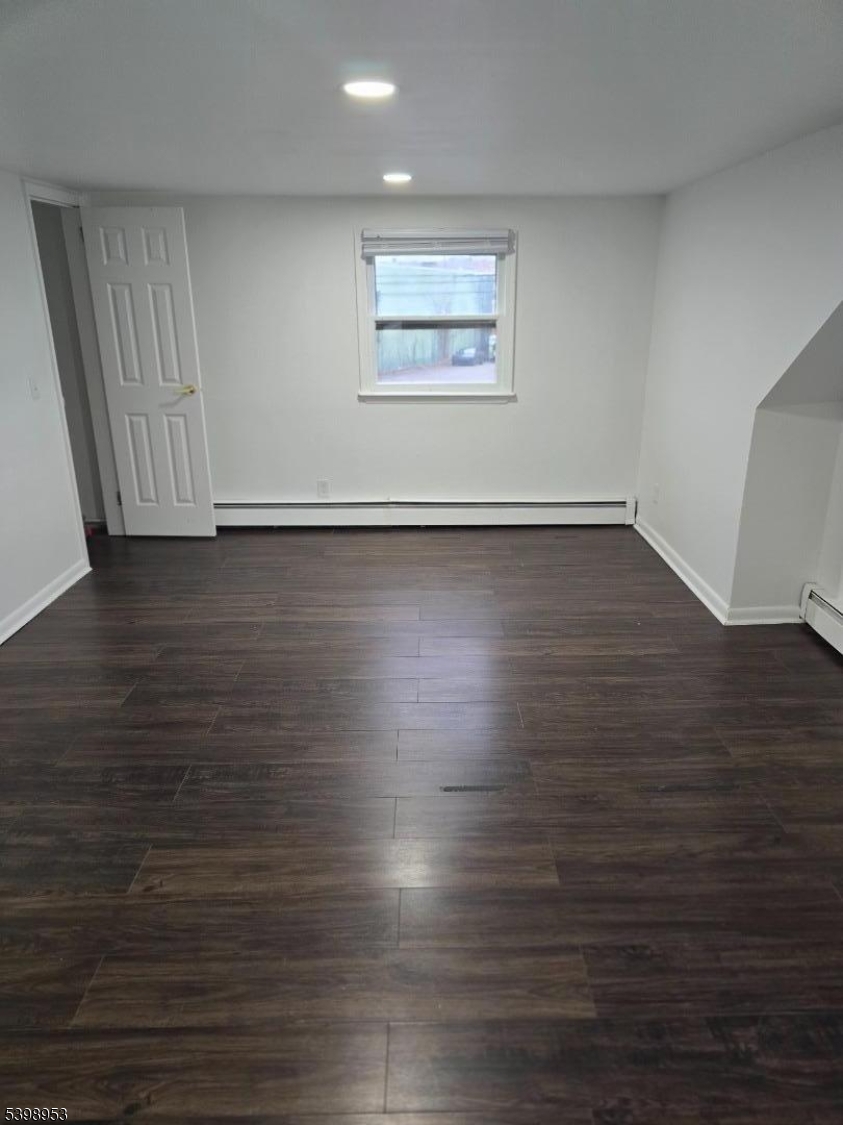 18 Donna Drive, Unit 2 Wood-Ridge, NJ 07075 - Photo 3 of 15 an empty room with wooden floor and windows