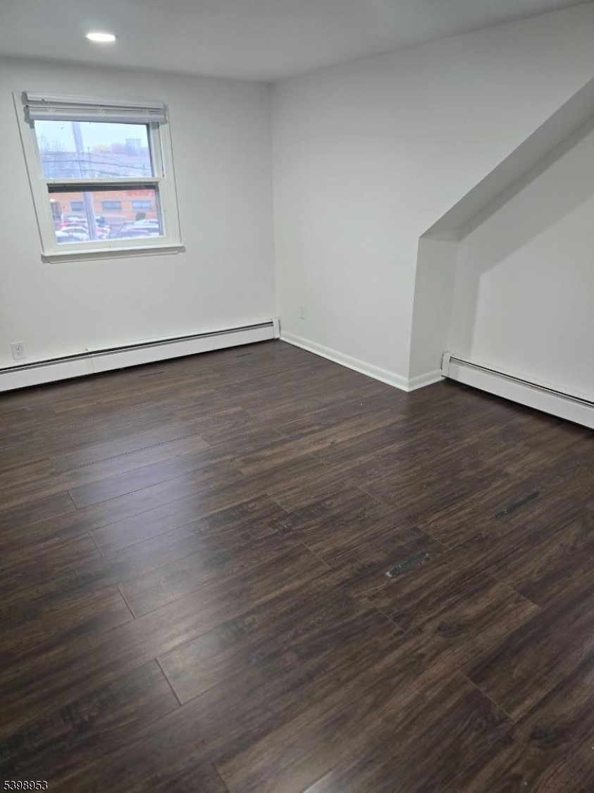 18 Donna Drive, Unit 2 Wood-Ridge, NJ 07075 - Photo 5 of 15 an empty room with wooden floor and windows
