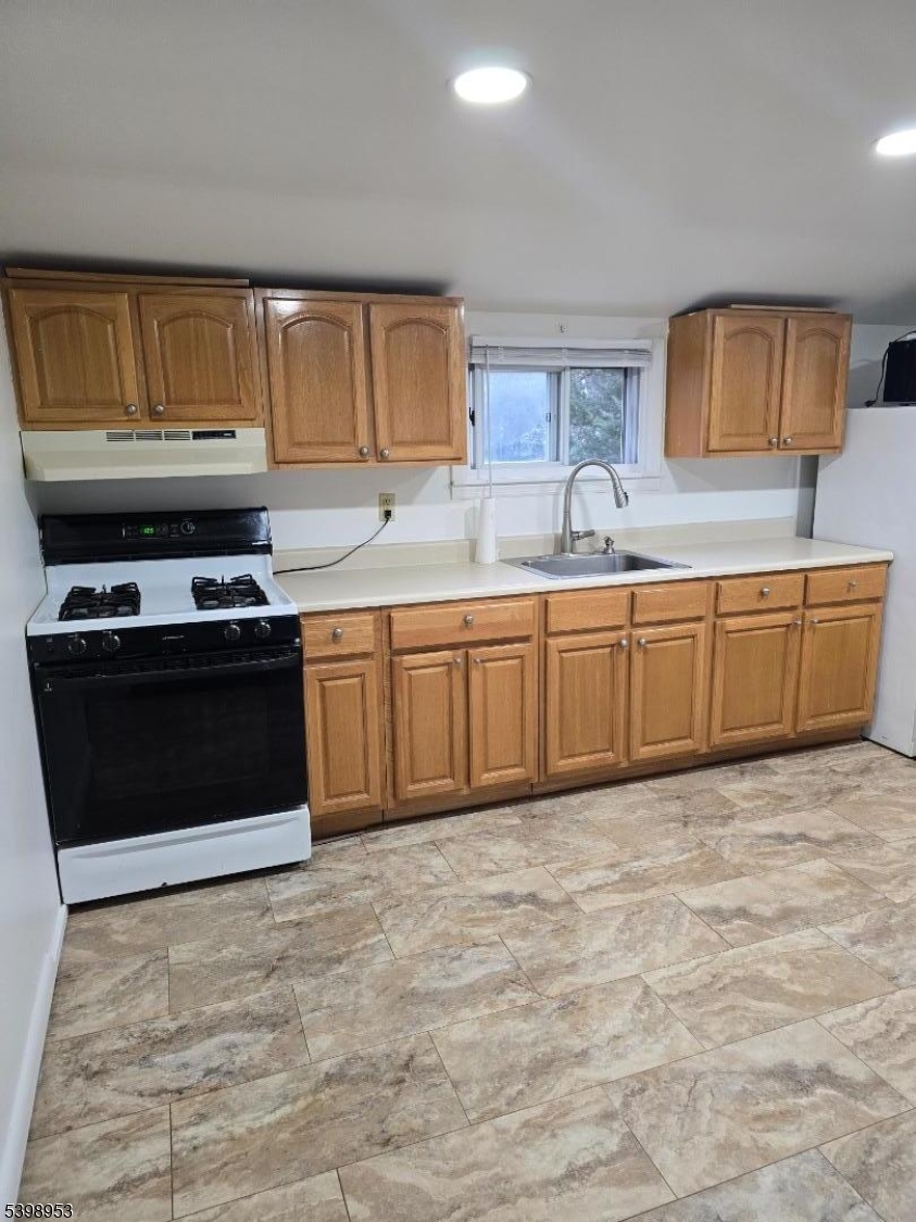 18 Donna Drive, Unit 2 Wood-Ridge, NJ 07075 - Photo 9 of 15 a kitchen with stainless steel appliances granite countertop a stove a sink and a microwave