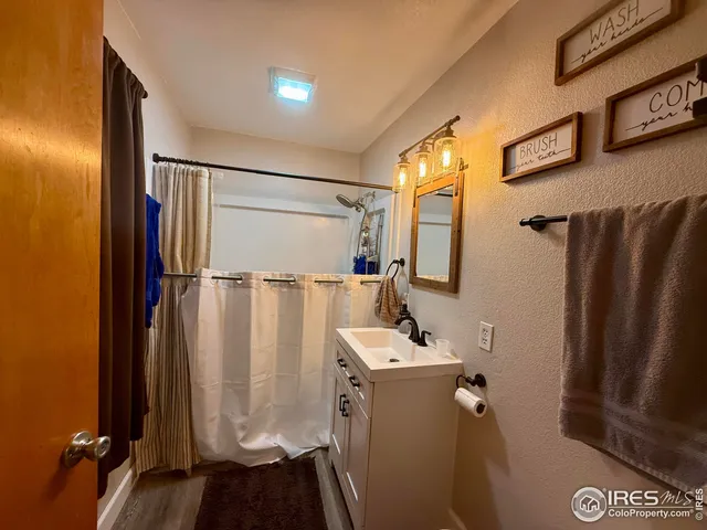 a bathroom with a shower a sink and a mirror