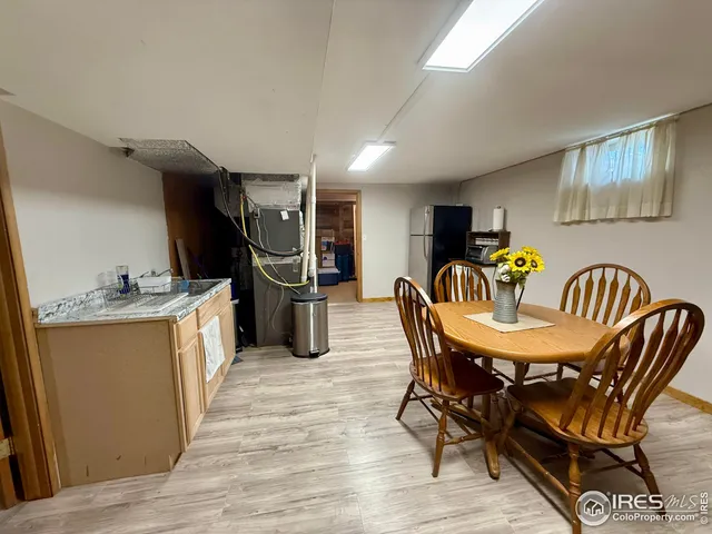 a view of a dining room with furniture and a kitchen